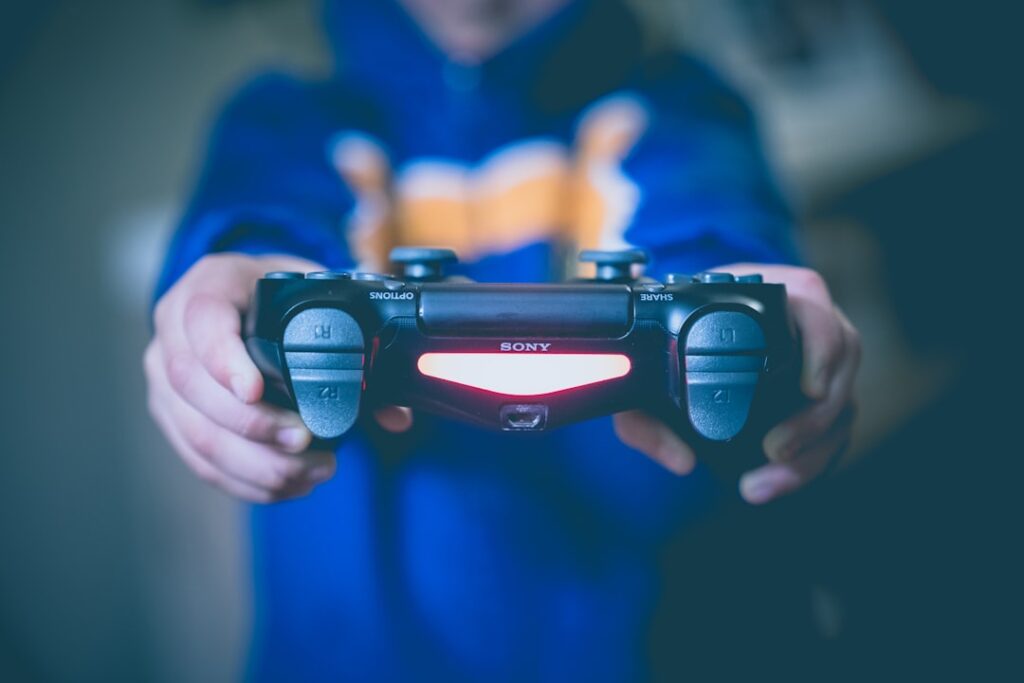 gaming tips and tricks - person holding black wireless controller