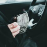 how much does car insurance cost - person holding white and black striped textile