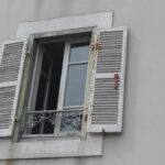 how to install window 11 - two windows with shutters open on a building