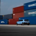 test import fixes - The rear view of the Hyundai IONIQ 5 N driving between stacked containers.