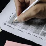 test - person writing on white paper